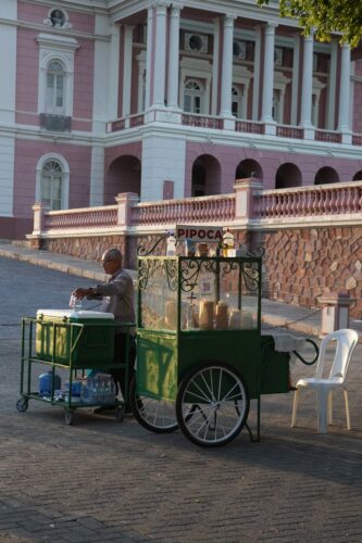 Popcorn vendor setting up at the historic Manaus Opera House in Brazil.