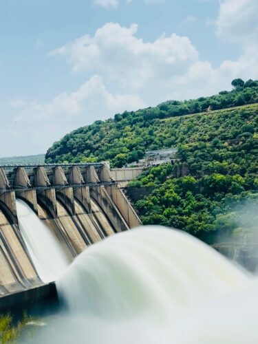 A breathtaking capture of a dam releasing water amidst lush greenery in Andhra Pradesh, India.