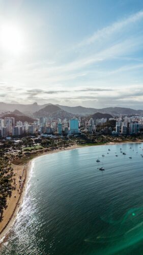 Stunning aerial view of Vitória's coastline, showcasing modern architecture and natural beauty.